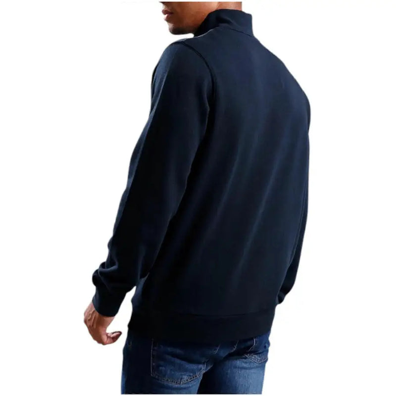 Men’s navy blue quarter-zip sweatshirt and jeans from Lyle & Scott for fall winter season