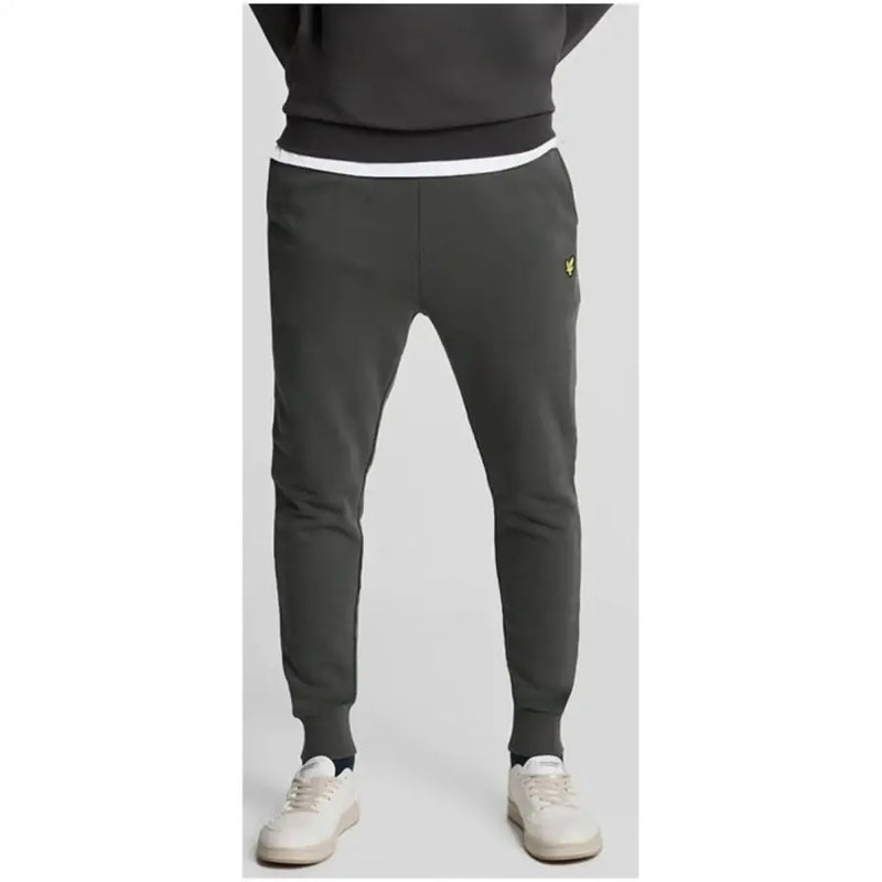 Lyle & Scott men’s grey cotton trousers with front pockets featuring a white waistband and yellow logo on the thigh