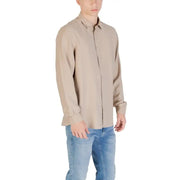 Man wearing beige long sleeve shirt and blue jeans in Beige and Tan Long Sleeve Shirts with Blue Jeans product image