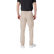Man showcasing Replay Men Beige Trousers featuring zip and button closure