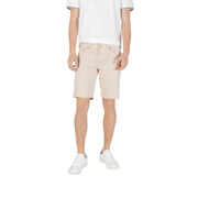 Man wearing beige shorts and white sneakers from Mens Casual Shorts T Shirt And Sneaker Collection