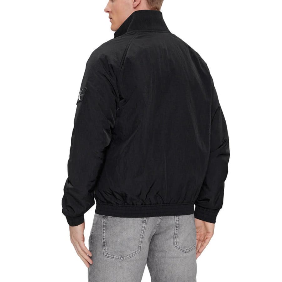 Man in Calvin Klein Jeans black bomber jacket
