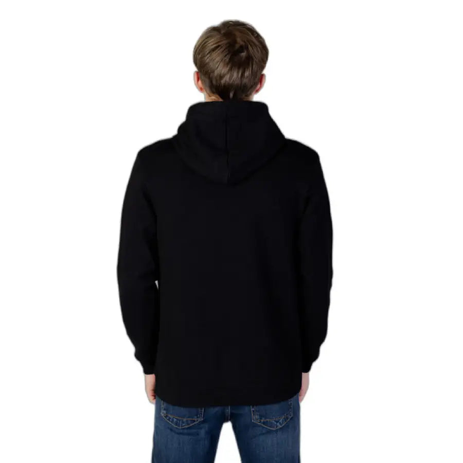 
                      
                        Man in black hoodie from Icon Men Sweatshirts showcasing urban city style fashion
                      
                    
