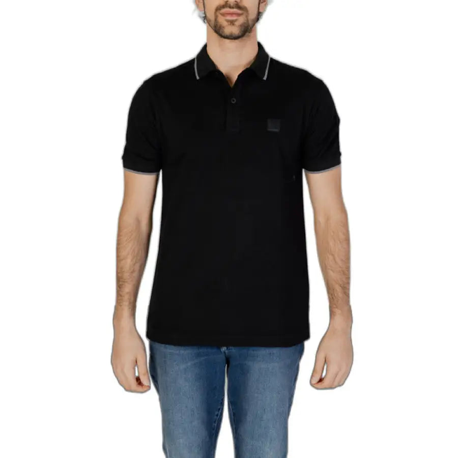 
                      
                        Man in Boss black polo shirt showcasing urban city style fashion
                      
                    