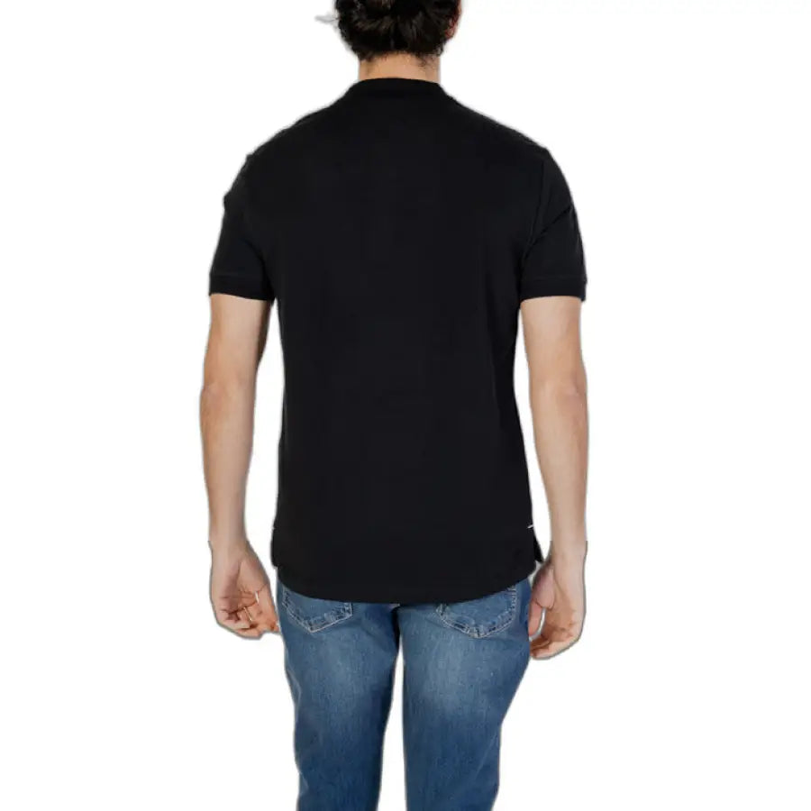 
                      
                        Man in black Gas-Gas polo shirt showcasing urban city style fashion
                      
                    