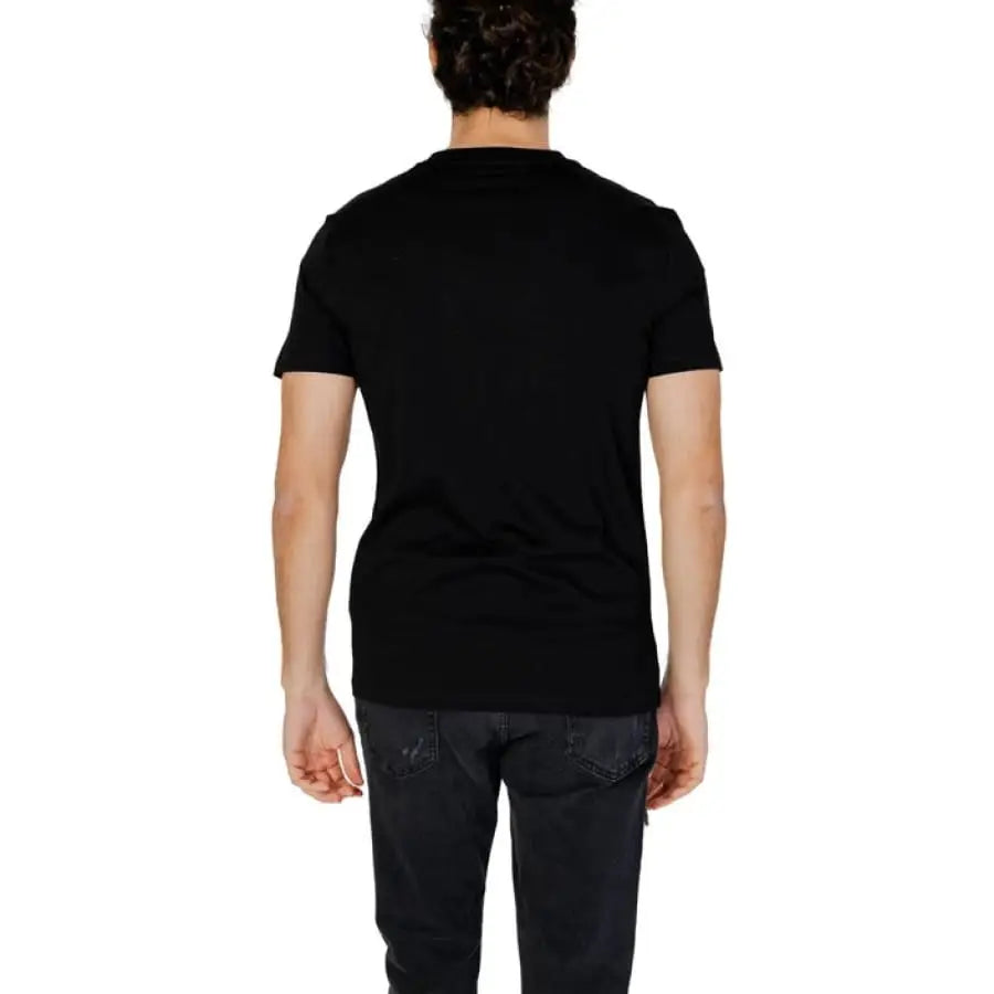 Man wearing Antony Morato black T-shirt and jeans.