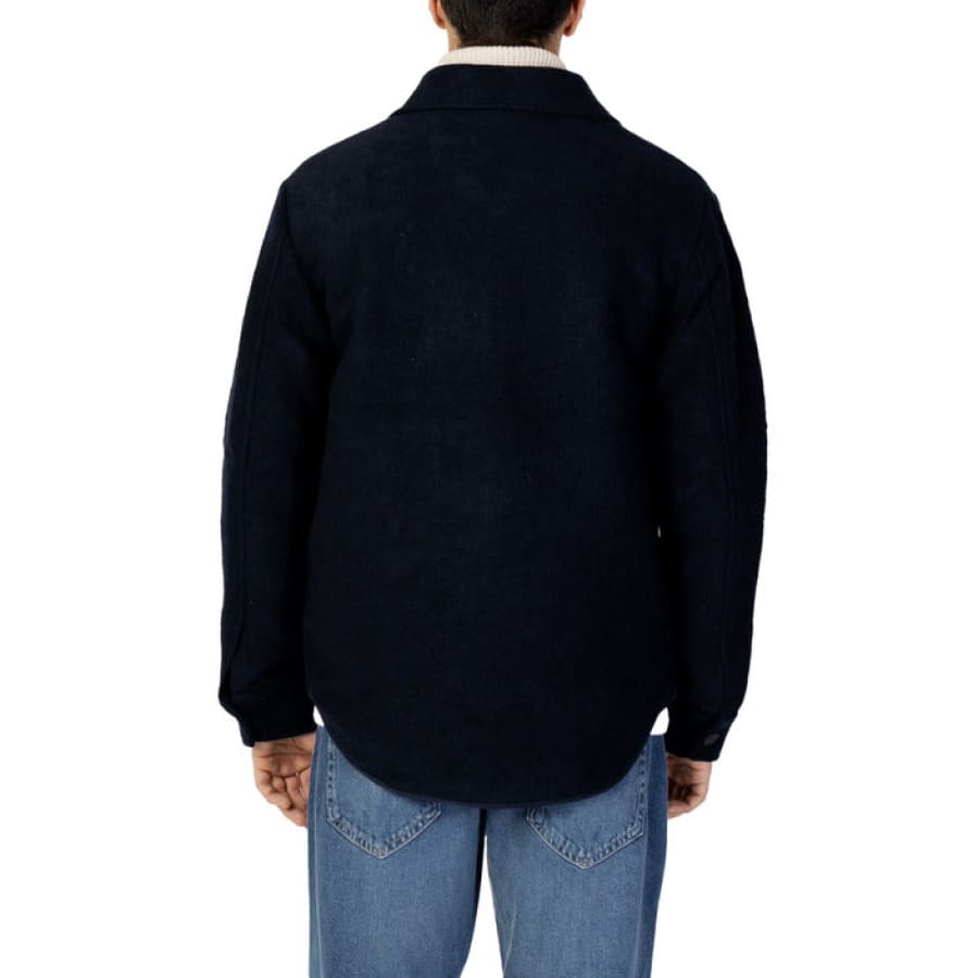Man modeling Selected Selected Men Jacket in black sweater and jeans