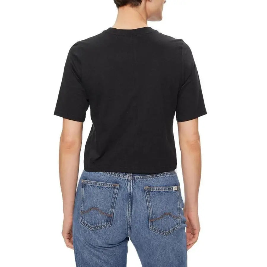 
                      
                        Man modeling Calvin Klein sport black t-shirt and jeans for women’s line
                      
                    