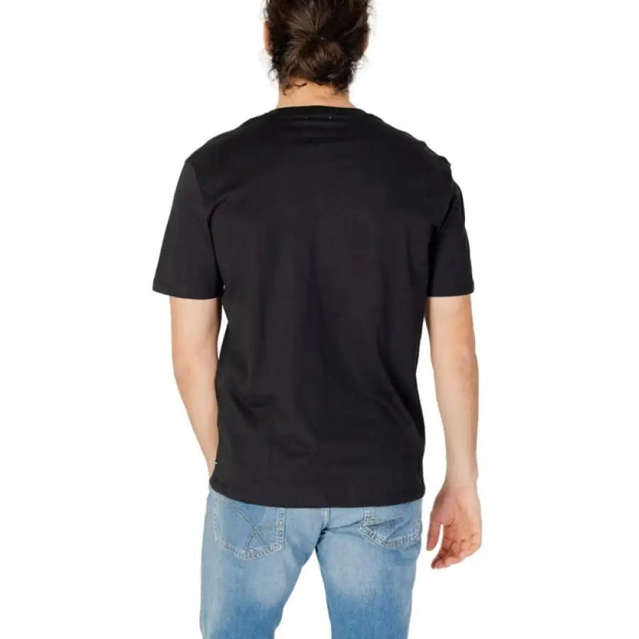 Man modeling Gas Gas men’s t-shirt with white logo on black fabric