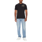 Man wearing Calvin Klein Men’s Black Crew Neck T Shirt with light blue jeans