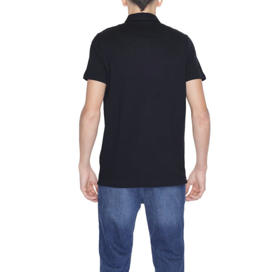 Man modeling U.S. Polo Assn. black tee and jeans for urban style clothing