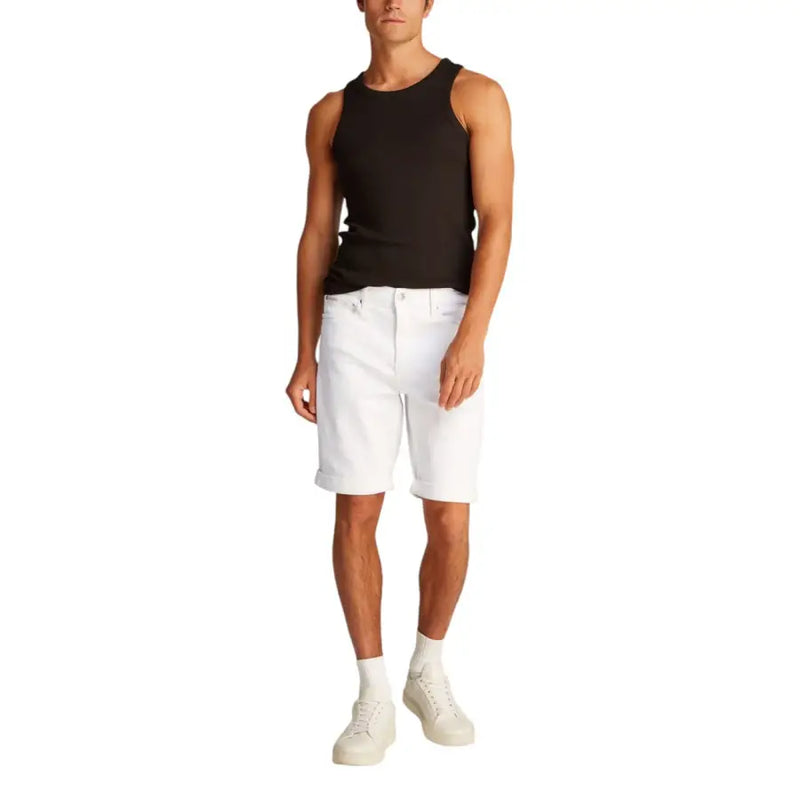 Man wearing a black tank top and white denim shorts for Men’s Black Tank Top and White Denim Shorts product