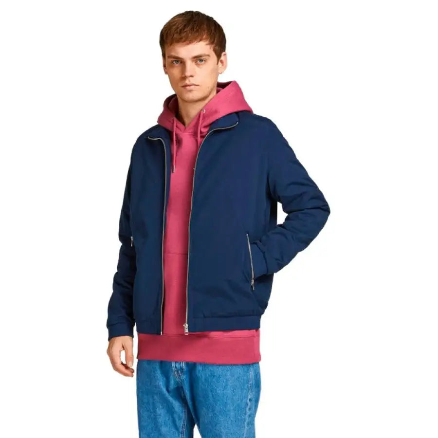 
                      
                        Jack & Jones man in urban style blue jacket and pink sweater for city fashion
                      
                    