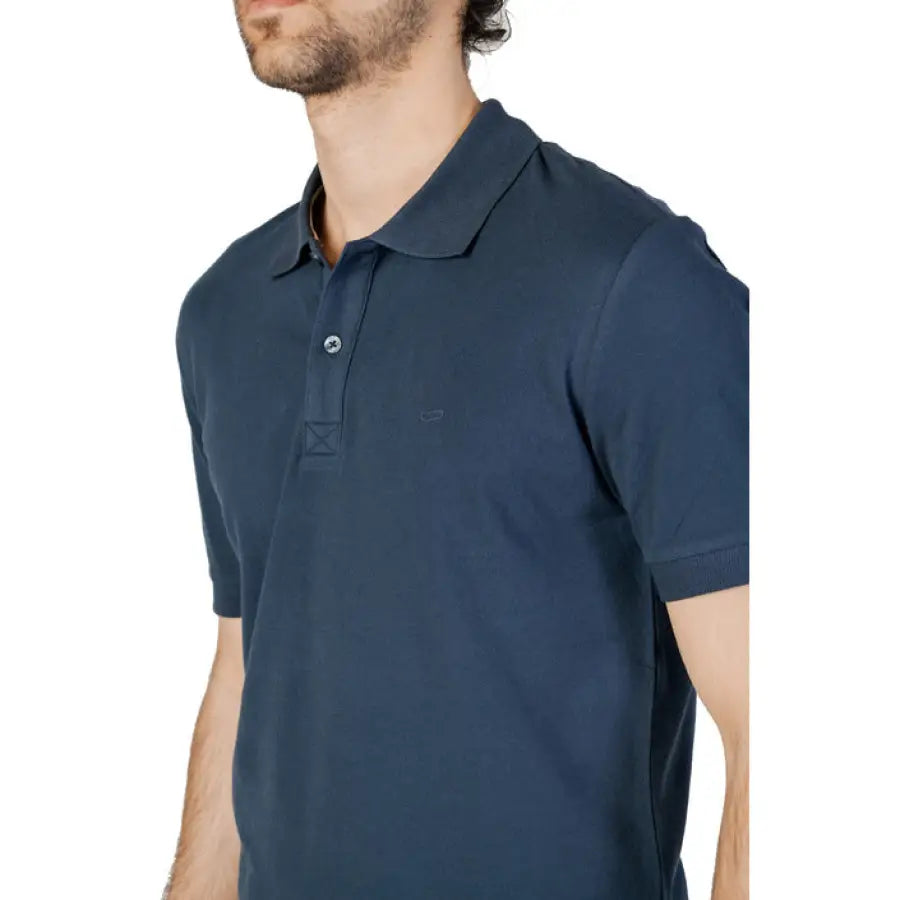 
                      
                        Man in blue Gas-Gas Polo showcasing urban city style clothing
                      
                    