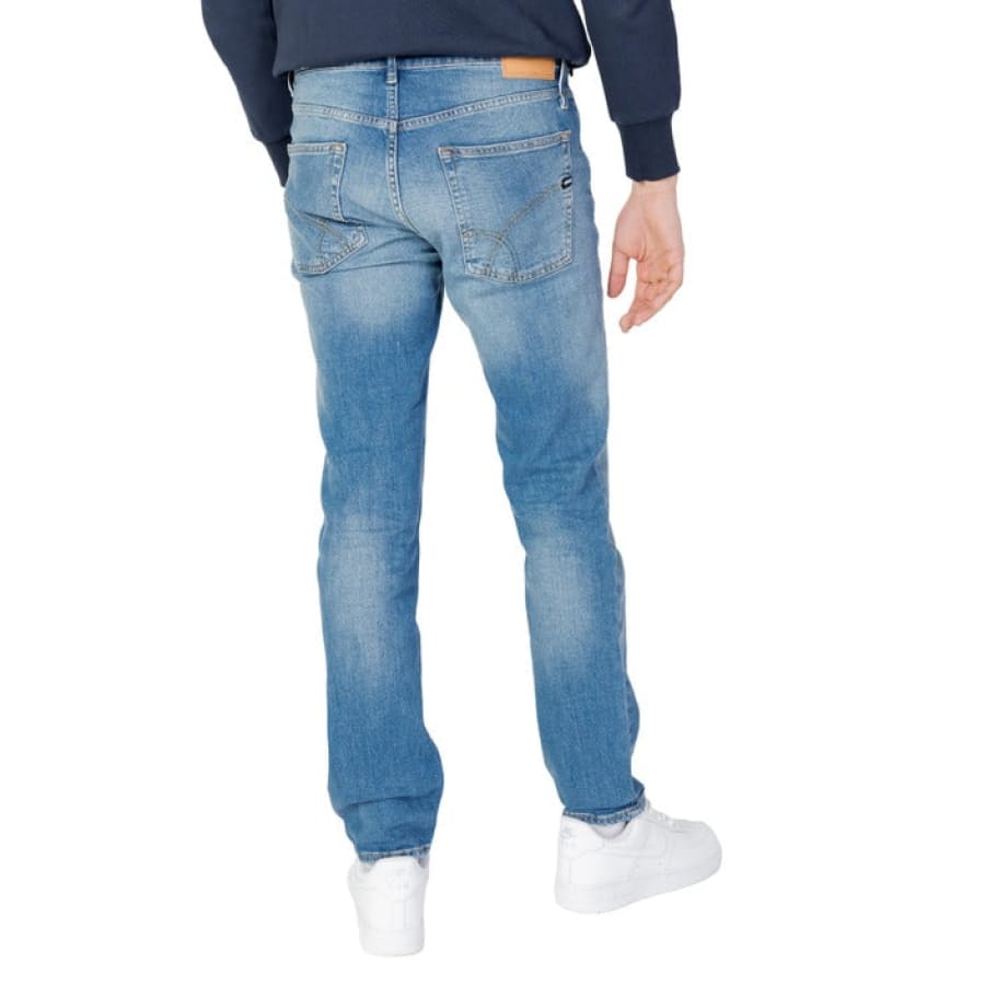 Man modeling Gas Gas Men’s jeans, wearing blue sweatshirt