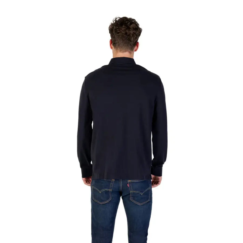 Man wearing Navy Long Sleeved Polo Shirt in dark blue with jeans, front view