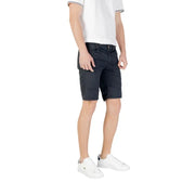 Man wearing dark shorts and white sneakers from Mens Casual Shorts T Shirt And Sneaker Collection