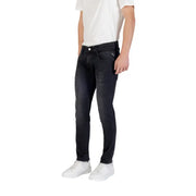 Man wearing dark wash slim fit jeans demonstrating a stylish casual look