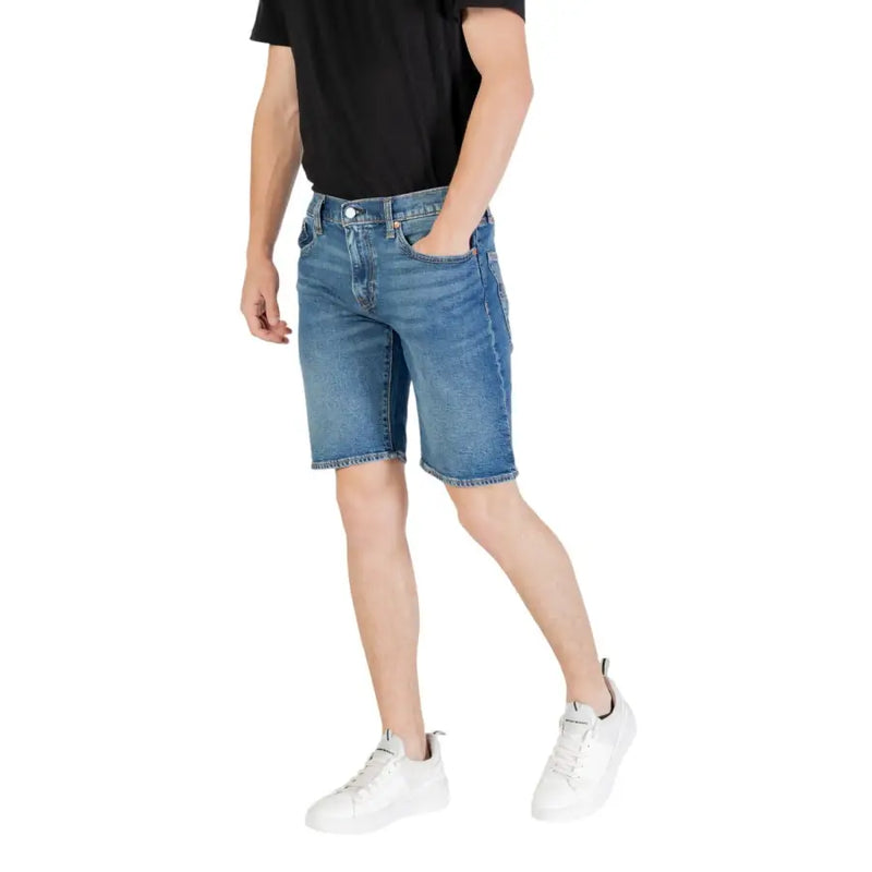 Man wearing stylish blue denim shorts suitable for casual summer wear