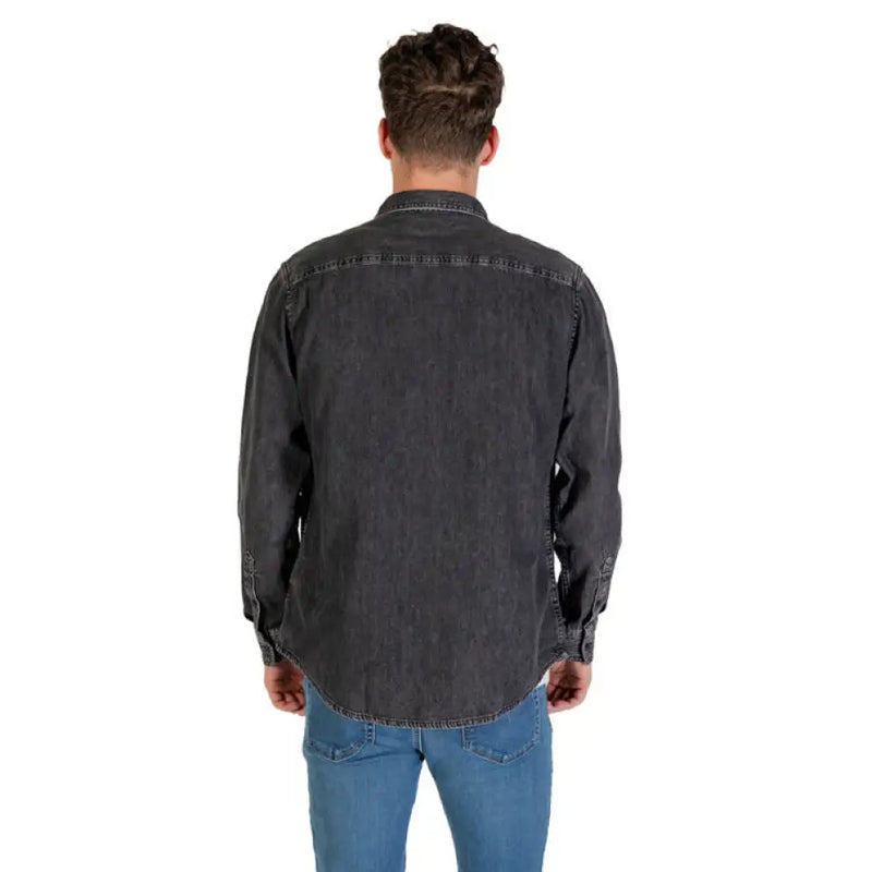 Man wearing a men’s gray denim long sleeve shirt showcasing casual style