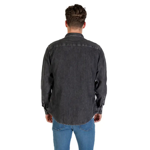 Man wearing a men’s gray denim long sleeve shirt showcasing casual style