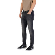 Man wearing gray slim fit jeans and black sneakers from Gray Slim Fit Jeans collection