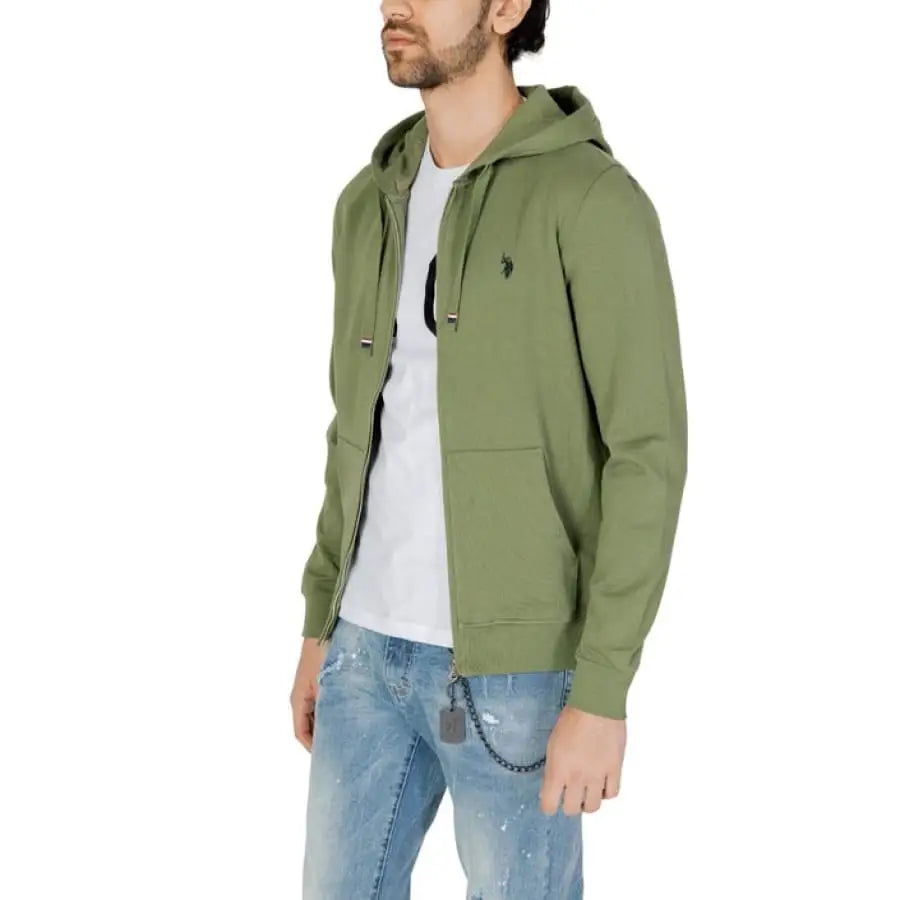 Man in U.S. Polo Assn. green jacket and jeans, showcasing men’s sweatshirts and apparel.