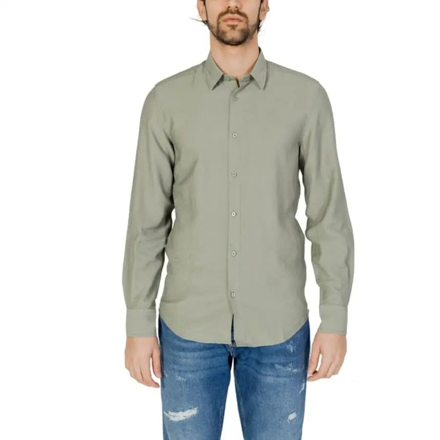 Model in Antony Morato shirt wearing jeans and a green Antony Morato top.