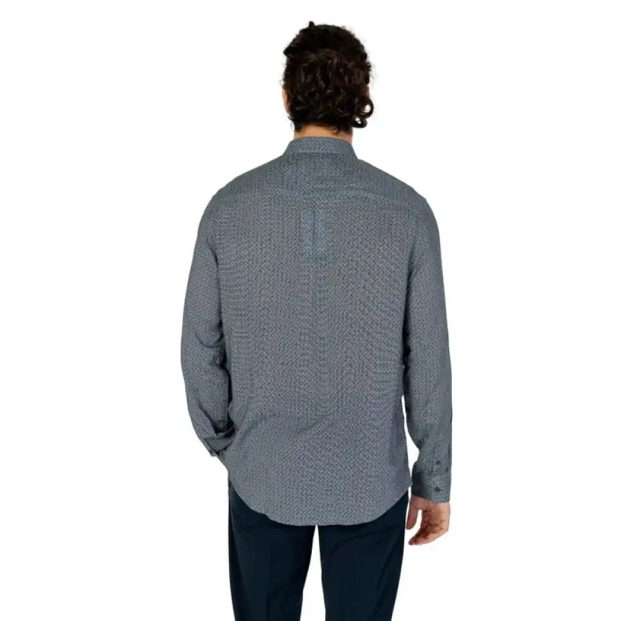 Man in Armani Exchange grey shirt and black pants showcasing Armani Exchange men’s collection
