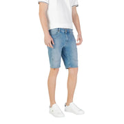 Man wearing light blue denim shorts and white sneakers, showcasing casual summer style