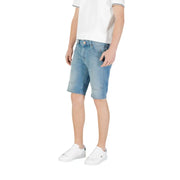 Man wearing light blue denim shorts paired with white sneakers for a casual look