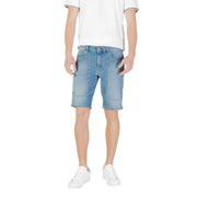 Man wearing light blue denim shorts and white sneakers for Men’s Light Blue Denim Shorts with White Sneakers
