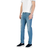 Man wearing light blue jeans and black slip-on shoes for Men’s Light Blue Jeans and Black Slip-On Shoes product