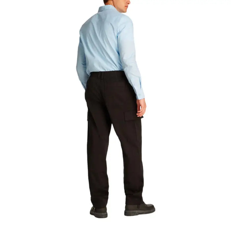 Man wearing a light blue shirt and black cargo pants, showcasing men’s casual attire