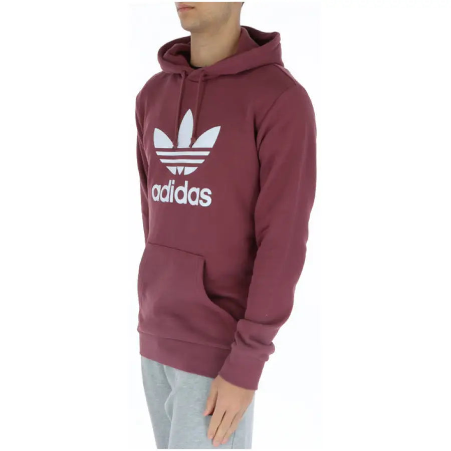 Man in Adidas maroon hoodie embodying urban city fashion
