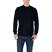 Man wearing navy textured long sleeve sweater and jeans showcasing stylish casual wear