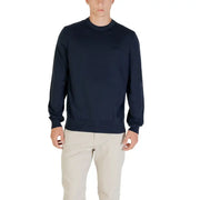 Man wearing a navy blue sweater and khaki pants for a stylish casual look