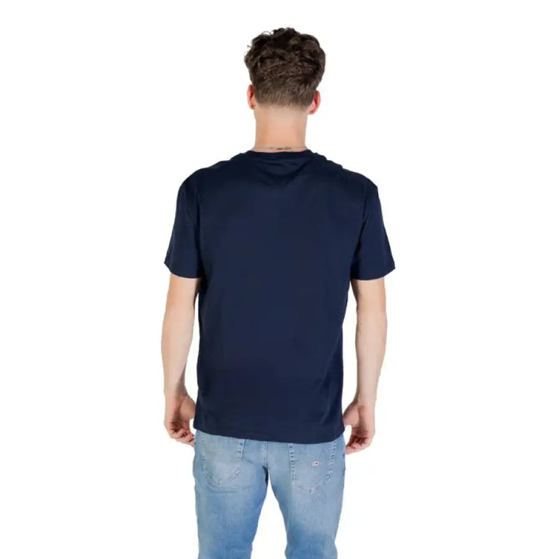 Man wearing a navy blue T shirt and jeans displayed in Tommy Jeans Navy Blue T Shirt product image