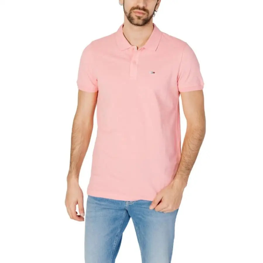 
                      
                        Man in Tommy Hilfiger Jeans pink polo shirt.
                      
                    