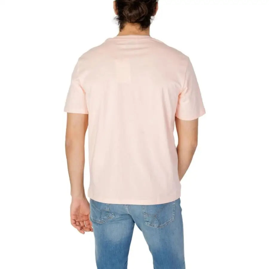 Man wearing Gas Gas Men T-Shirt in pink with jeans.