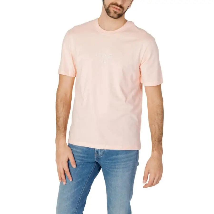 Man modeling Gas Gas men t-shirt in pink with jeans.