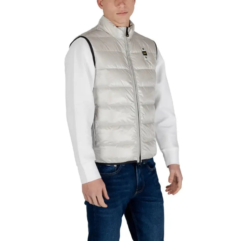 Man modeling a Light Gray Puffer Vest for Men, showcasing its sleek silver design