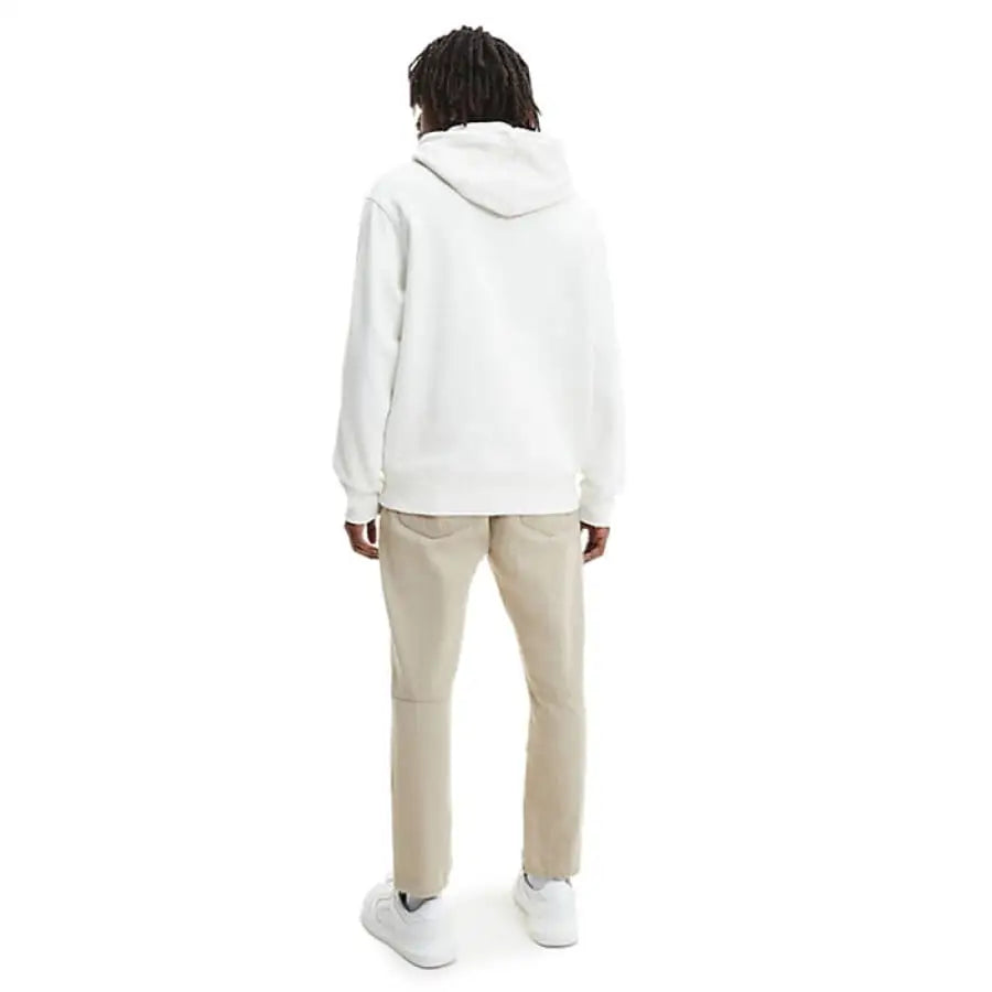 Man wearing Calvin Klein Jeans white hoodie and khaki pants