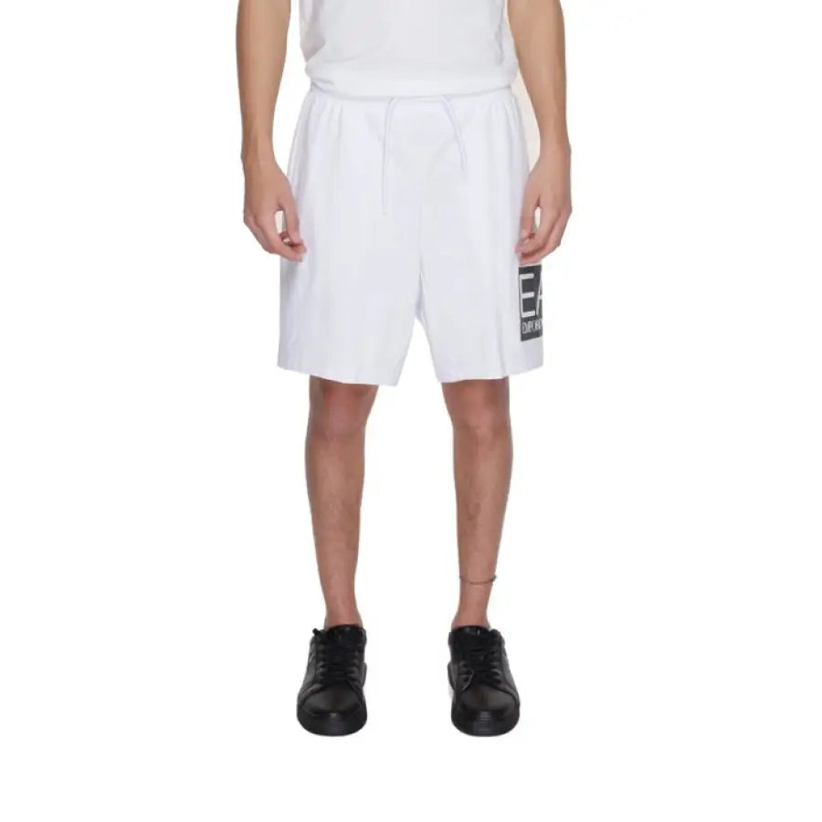 
                      
                        Ea7 Men Shorts in urban city style with man wearing white shorts and black sneakers
                      
                    
