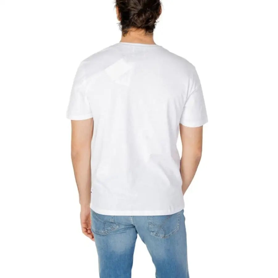 Man modeling Gas Gas Men T-Shirt in white, paired with jeans.