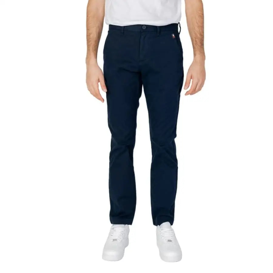 
                      
                        Man wearing Tommy Hilfiger Jeans in white t-shirt and black pants.
                      
                    