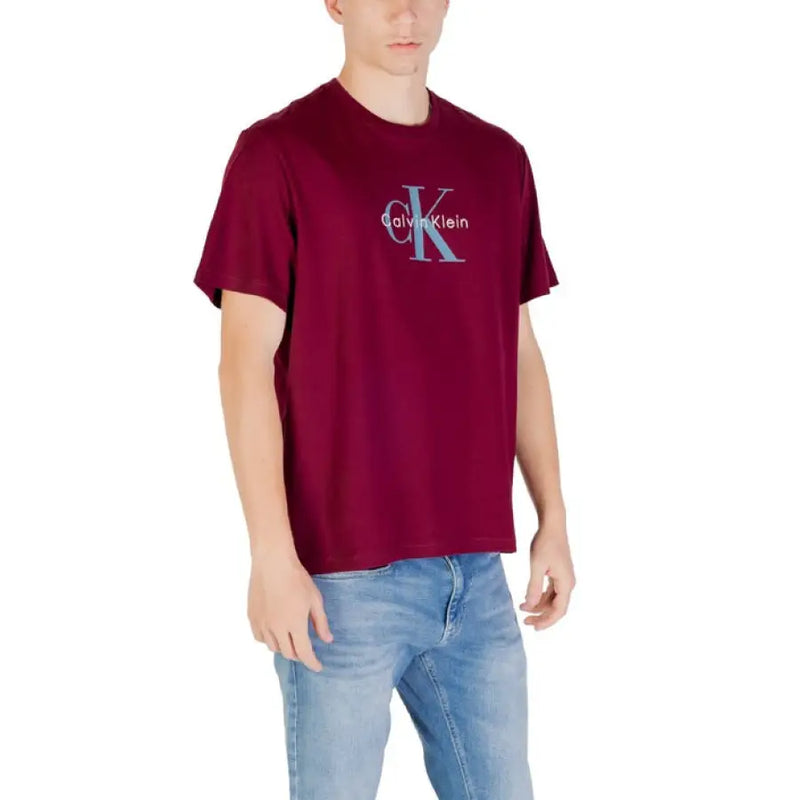 Maroon Calvin Klein T-shirt paired with blue jeans displayed as a fashion product
