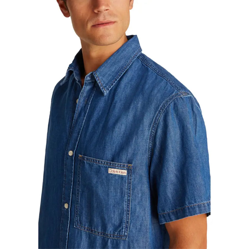 Men blue denim short sleeved button up shirt with chest pocket featuring Calvin Klein brand label