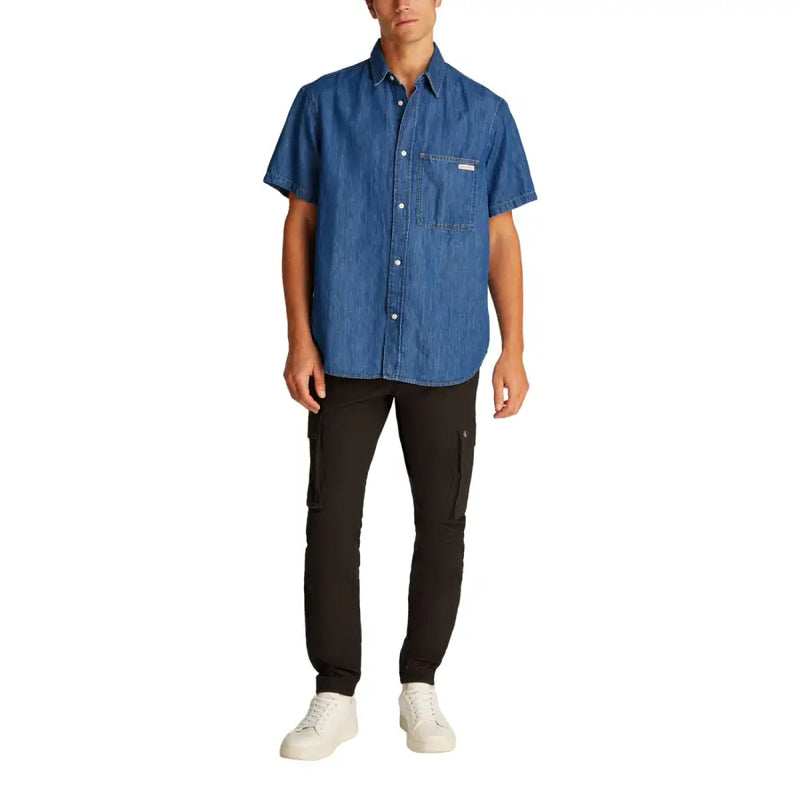 Men blue denim short sleeved shirt featuring a chest pocket and white buttons in a classic button-up style