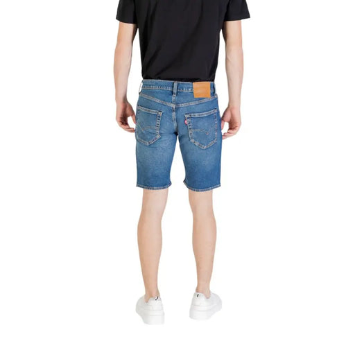 Men’s blue denim shorts back side showing classic five-pocket design and tan leather brand patch on waistband